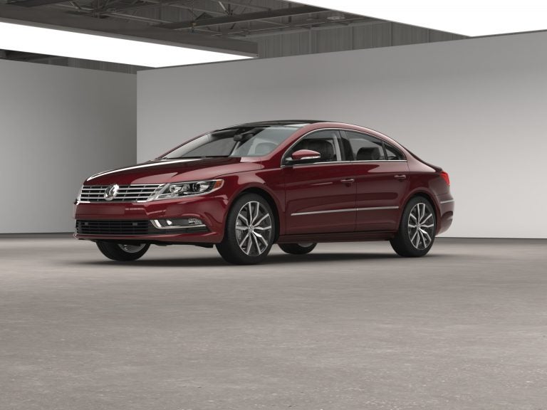 2016 Volkswagen CC V6 4MOTION Executive in deep red parked in a showroom

