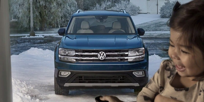 2020 Volkswagen Atlas front view parked in the snow outside a home