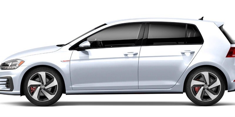 a white 2020 Volkswagen Golf GTI side view while parked in a showroom
