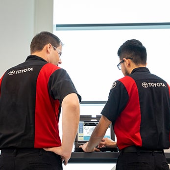Basic Car Maintenance and Servicing Checklist | Bennett Toyota of Lebanon | Two Toyota Mechanics look on computer at car diagnosis