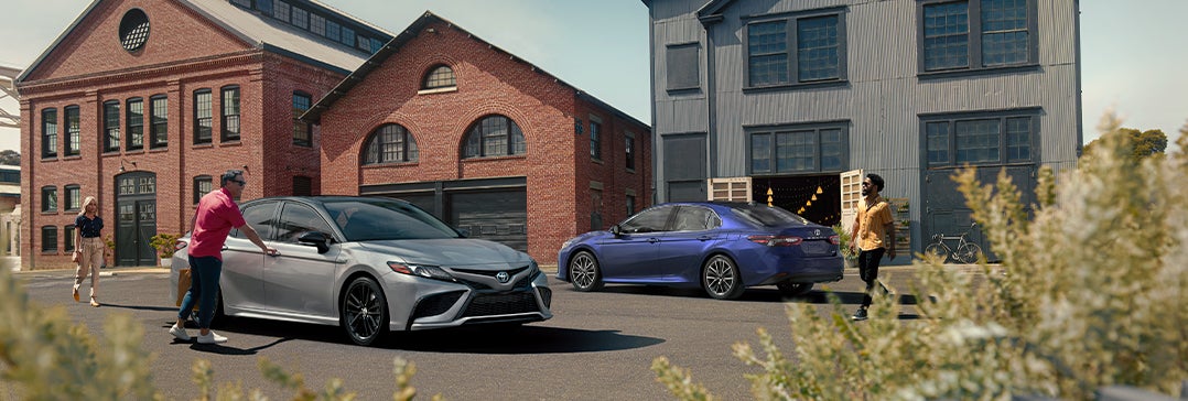 Model Features of the 2022 Toyota Camry at Bennett Toyota of Lebanon | Two Camry's parked outside beach homes
