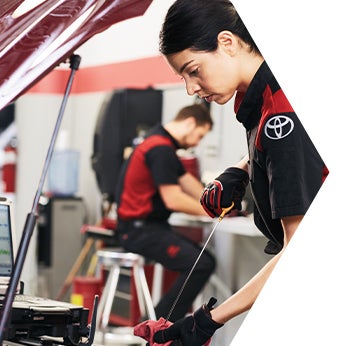Basic Car Maintenance and Servicing Checklist | Bennett Toyota of Lebanon | Toyota Mechanic checks oil from dipstick