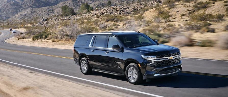 A 2023 Chevrolet Suburban driving down a road
