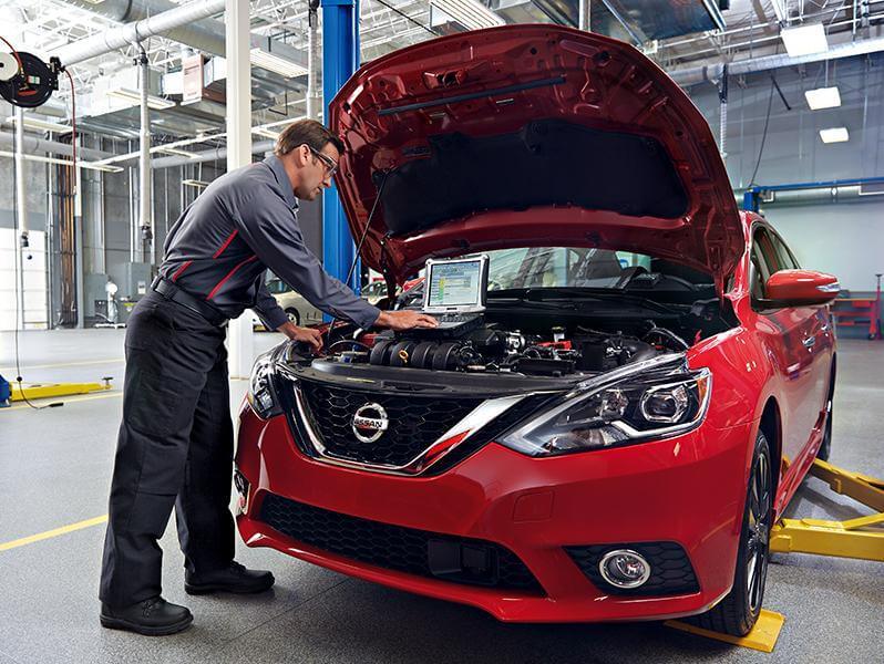 Image of a technician working on a Nissan vehicle.