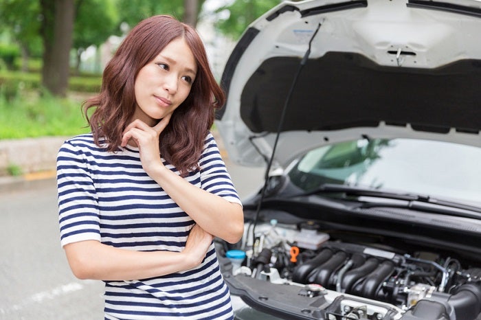 Woman_Standing_By_Broke_Down_Car