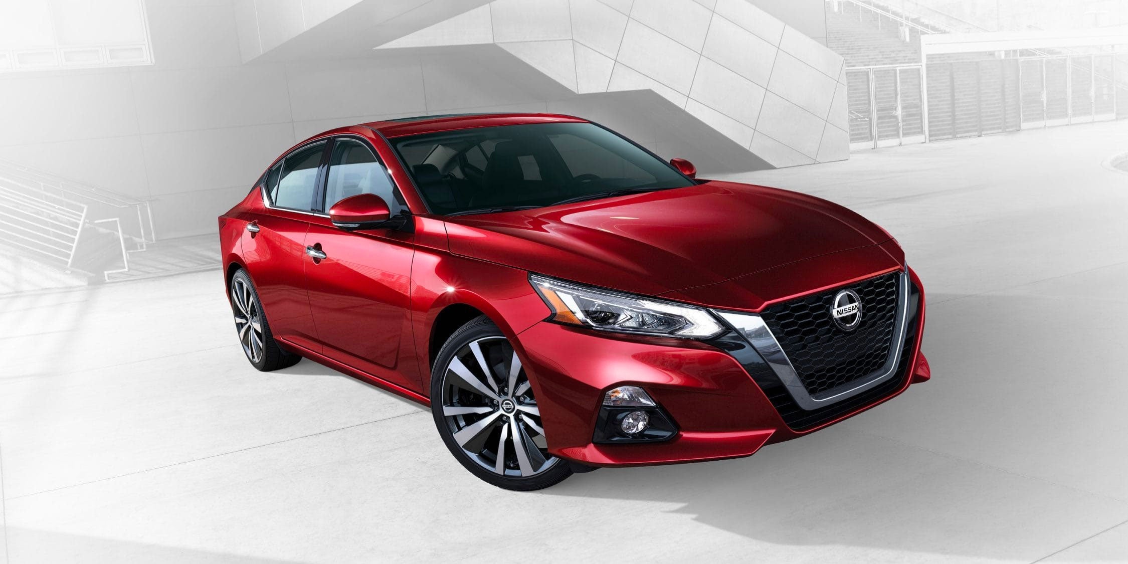 Image of a red 2019 Nissan Altima against a white background.