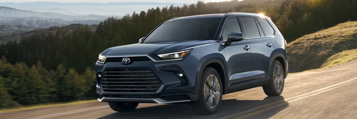 Blue 2026 Toyota Grand Highlander Driving Down the Road