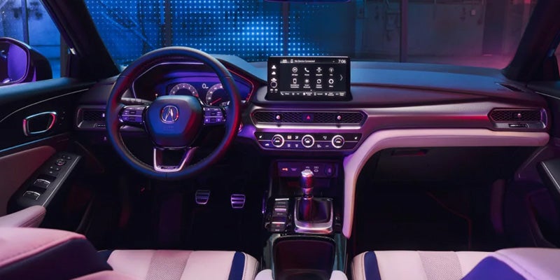 Interior view of an Acura vehicle showcasing the dashboard, steering wheel, and modern infotainment system.