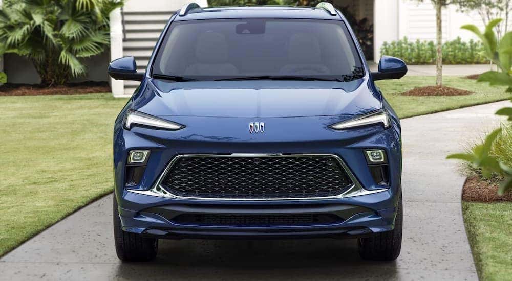 A blue 2024 Buick Encore GX is shown from the front parked in a driveway.