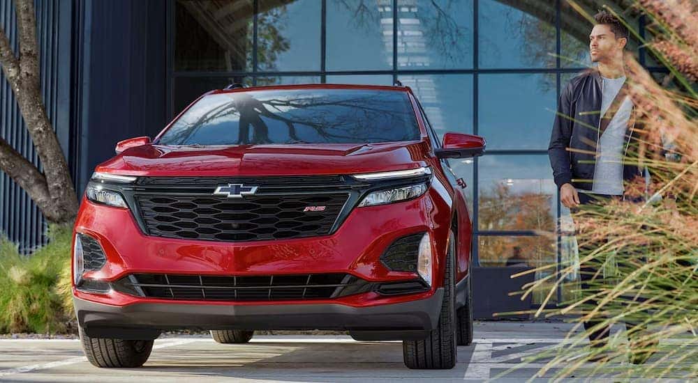 A red 2024 Chevy Equinox RS seen from a low angle.