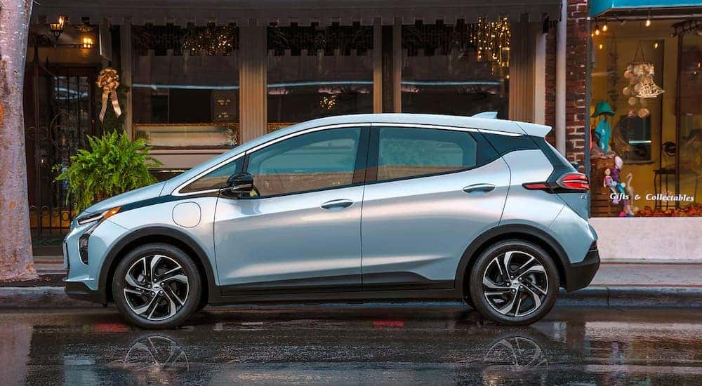 A silver 2022 Chevy Bolt EV is parked in front of a gift shop after leaving a Chevy EV dealer in Lexington.