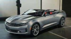 A grey 2020 Chevy Camaro RS is shown from the side parked in a garage.