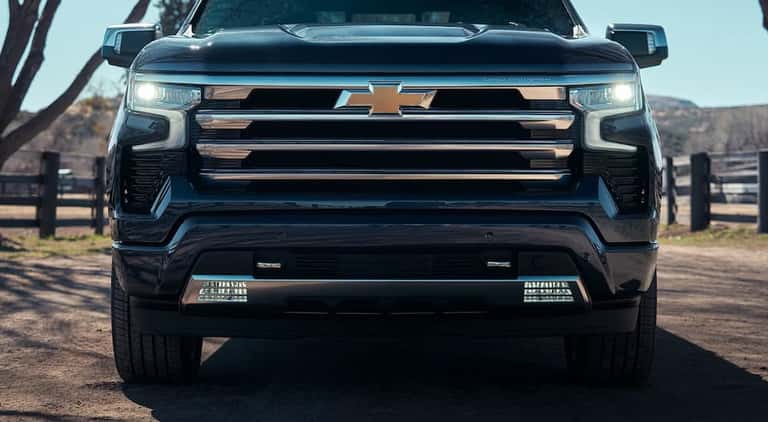 The front end of a black 2024 Chevy Silverado 1500 High Country is shown.