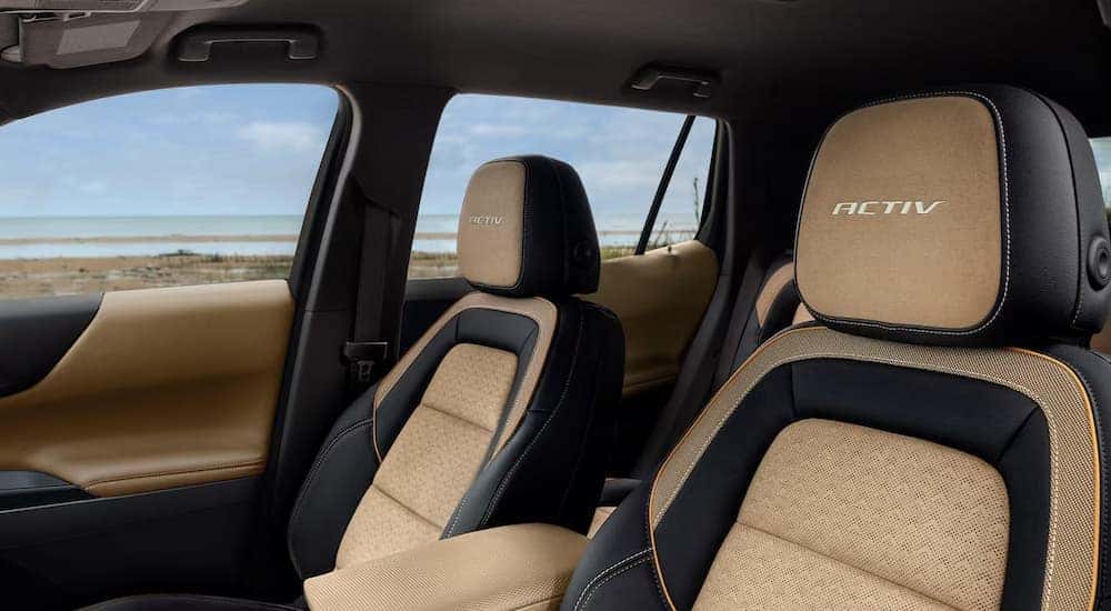 The black and brown front seats of a 2025 Chevy Equinox ACTIV for sale near Louisville.
