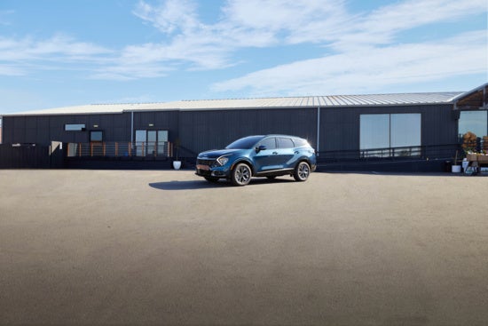 Kia Sportage SUV is parked on a spacious, empty lot.