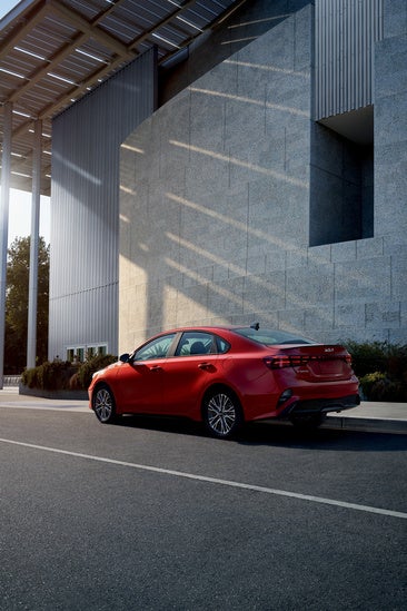 2023 Kia Forte is parked on a quiet urban street.