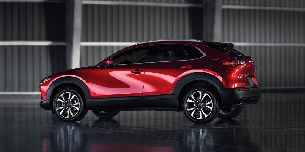 Red Mazda CX-30 compact SUV parked, showcasing its sleek design and modern features.