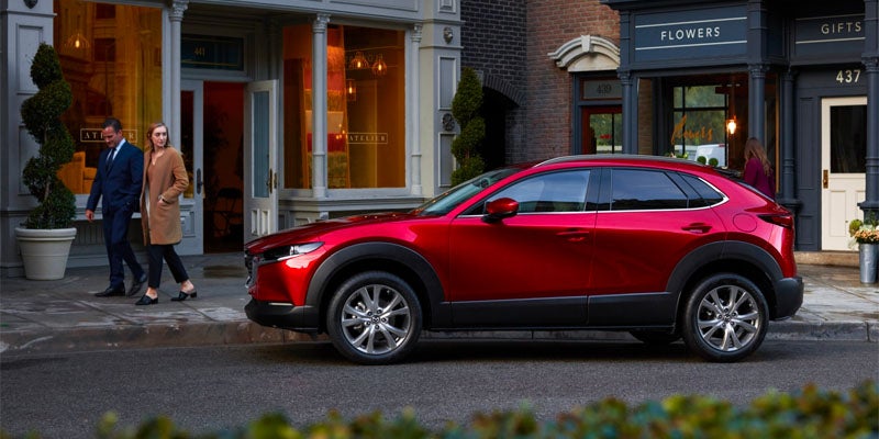The Mazda CX-30, a compact SUV, displayed in multiple colors, showcasing its modern look and options.
