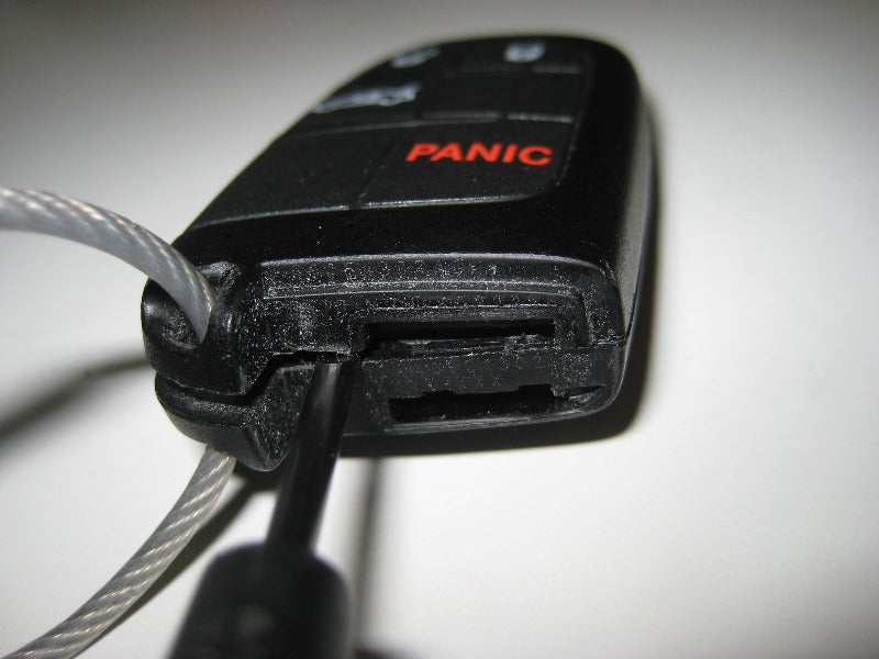 Key fob being pried apart.