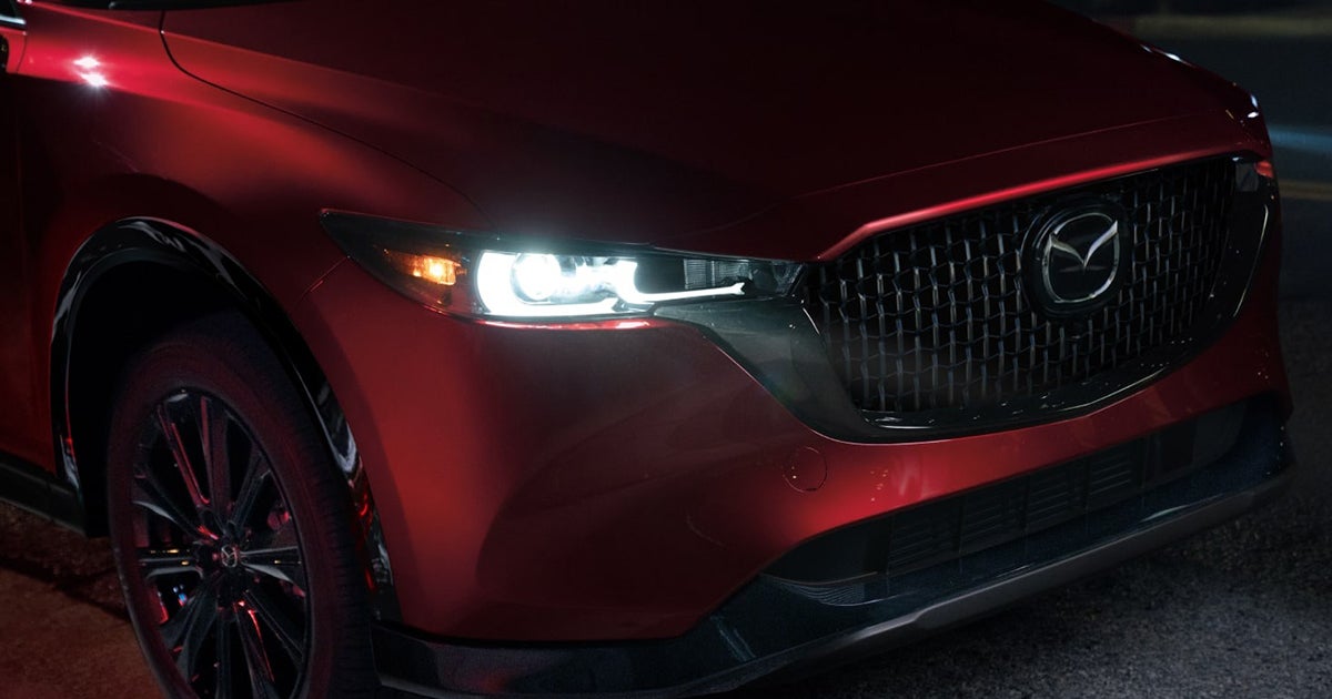 Close-up of Mazda CX-5 LED headlights and grille at night