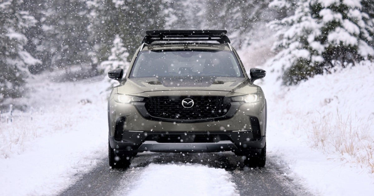 Mazda CX-50 SUV driving forward in heavy falling snow