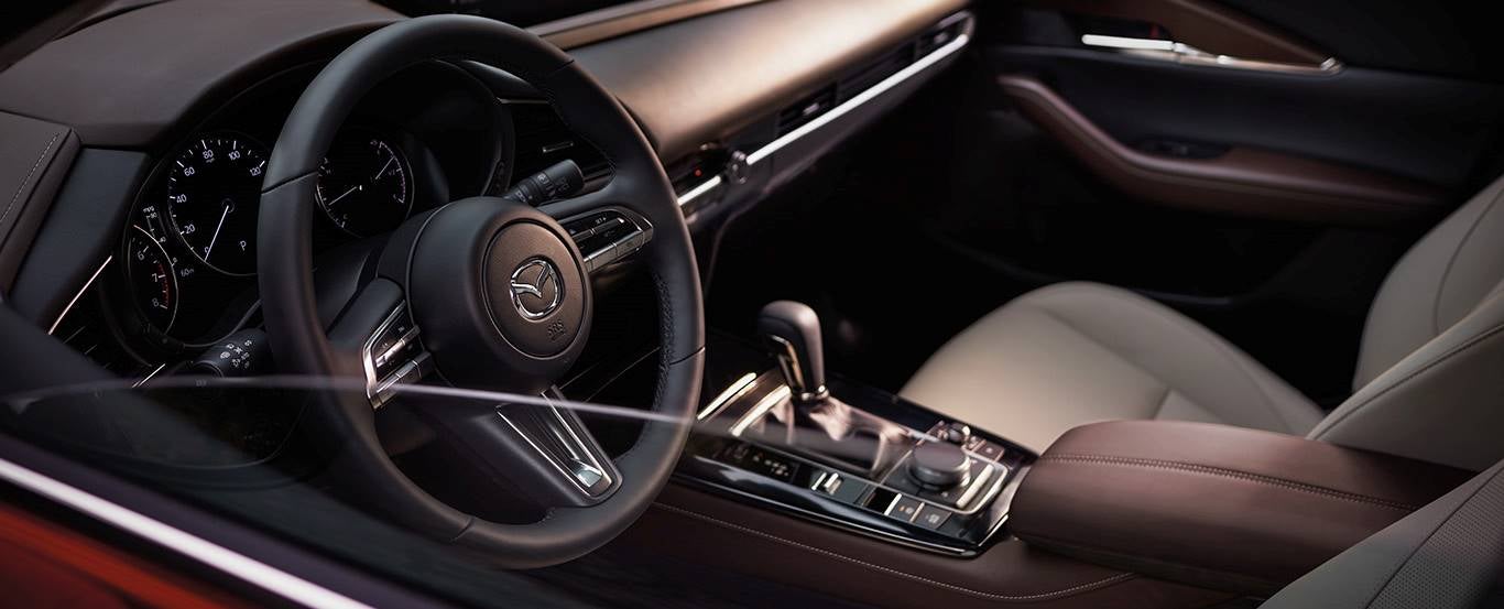 The dashboard of a vehicle equipped with Mazda safety features