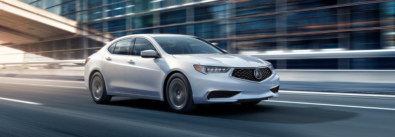 White 2019 Acura TLX zooming through the city