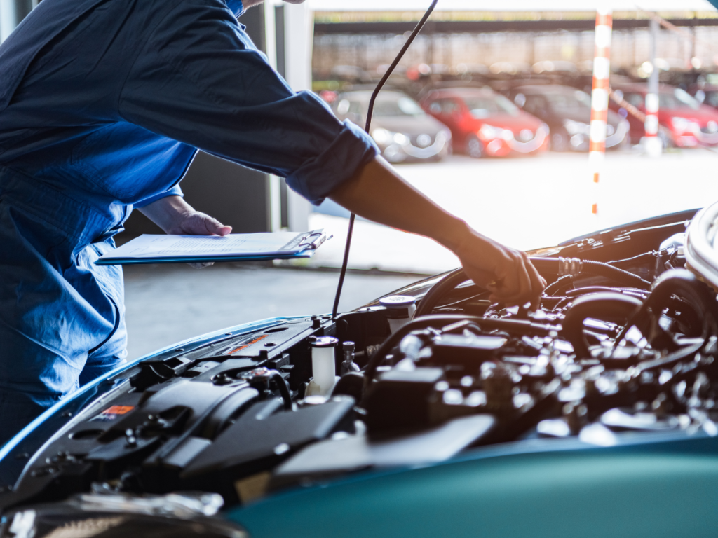 car mechanic checking car transmission