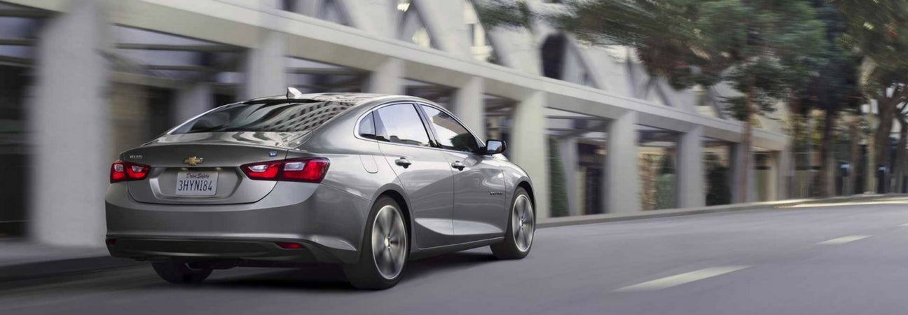A Chevy Malibu driving down the road