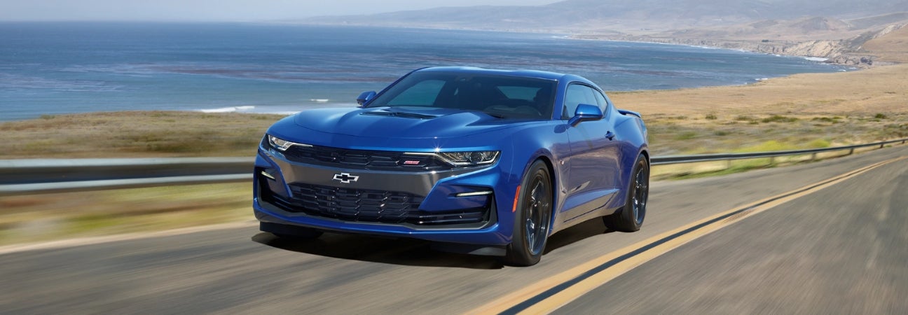 Blue 2018 Chevrolet Camaro cruising down the open road.