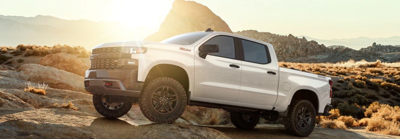 A white 2019 Chevrolet Silverado 1500 parked on rocks