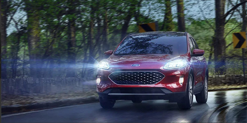 A red 2021 Ford Escape driving down the road.