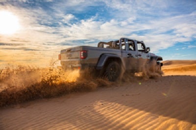 2021 Jeep Gladiator Gra Driving Over Dunes
