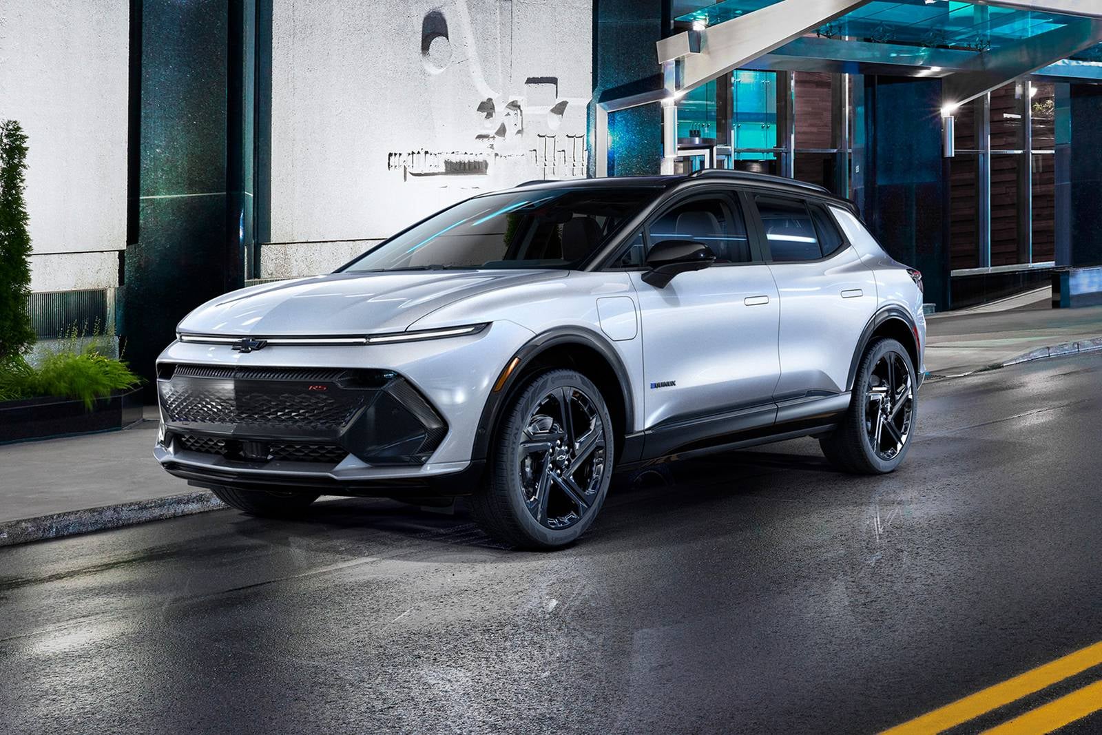 silver two-tone 2025 Chevy Equinox driving through a city