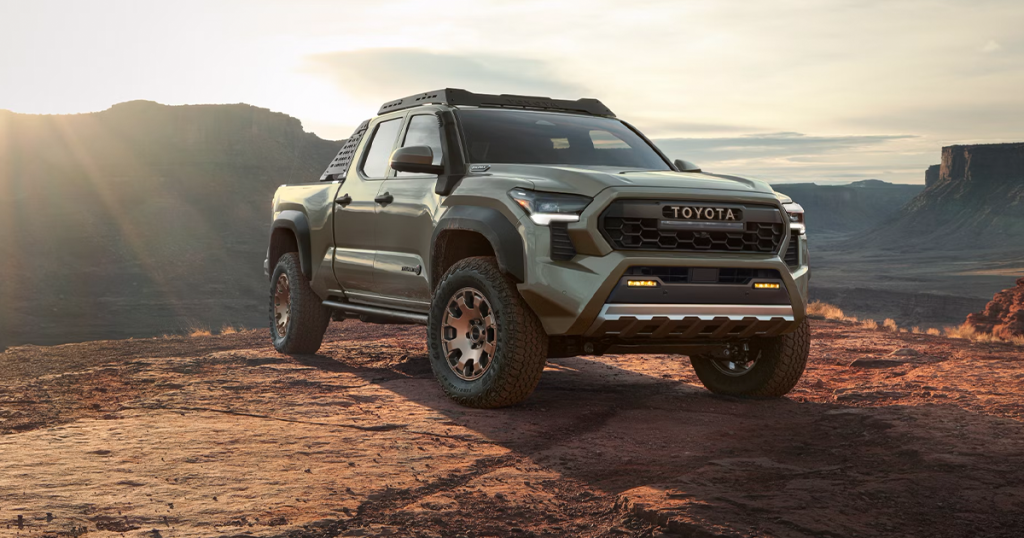 2024 Toyota Tacoma Trailhunter trim in Bronze Oxide color parked off road.