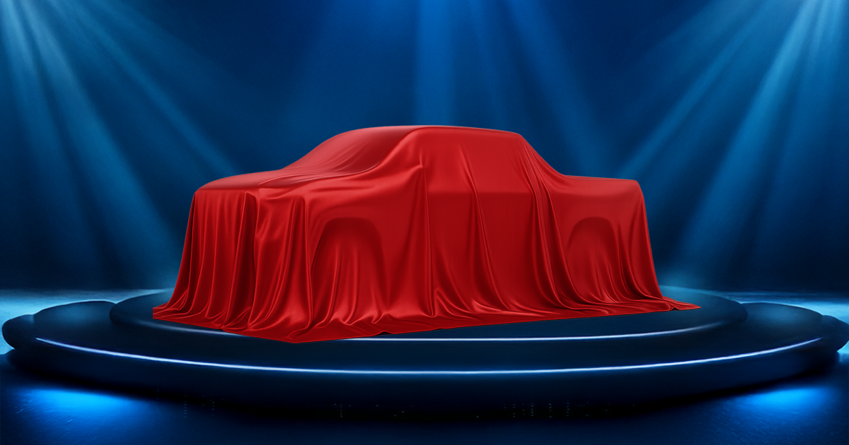 A Toyota truck hidden under a red cover on a platform.