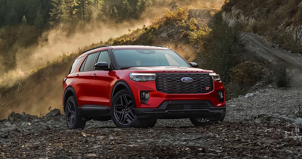 A red Ford Explorer parked off-road