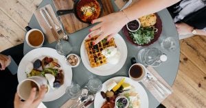 people sitting at a table eating breakfast