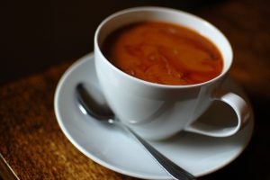 Cup of coffee in a white mug with a spoon.