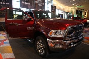 Red Dodge Ram sitting inside with all of the doors open.