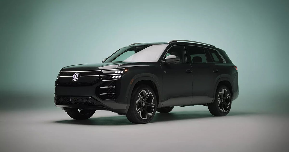 A black Volkswagen Atlas featuring a redesigned front fascia with an illuminated light bar and signature styling.