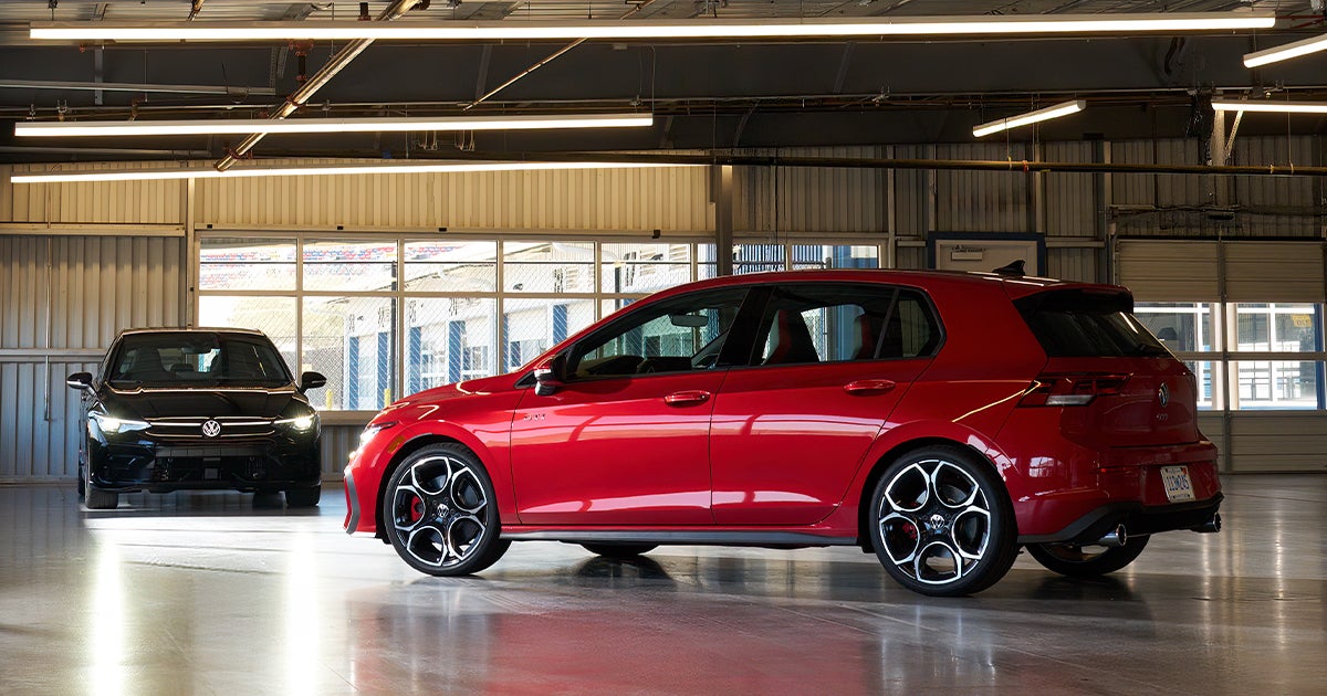 A red Volkswagen Golf GTI parked in a building.