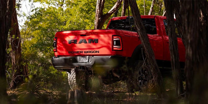 Back of a red 2025 RAM 2500 driving into a forest near Enumclaw, WA