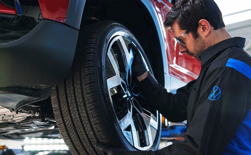 Volkswagen service technician replacing a tire