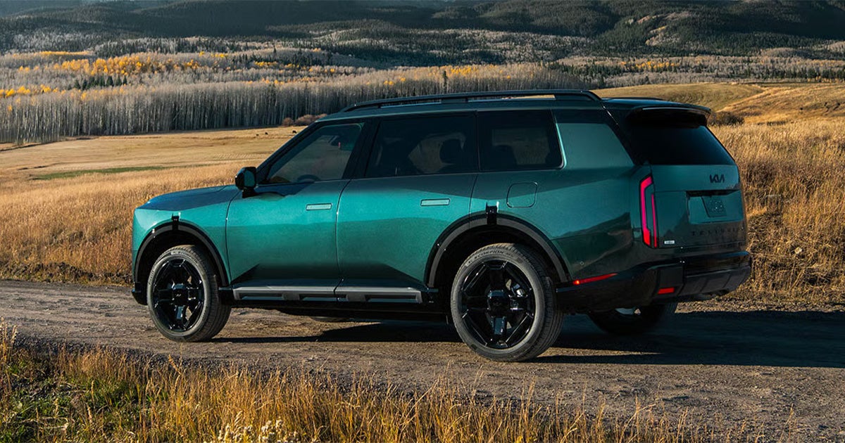 A 2027 Kia Telluride driving on a dirt road.