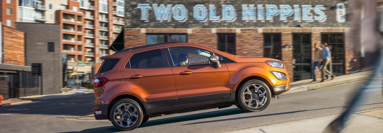 Orange 2019 Ford EcoSport climbing incline in city