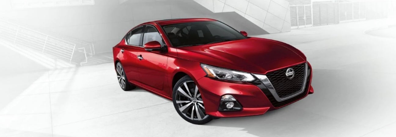 Red 2019 Nissan Altima in white industrial foreground