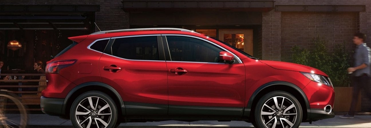 Red 2018.5 Nissan Rogue Sport rendered in a city