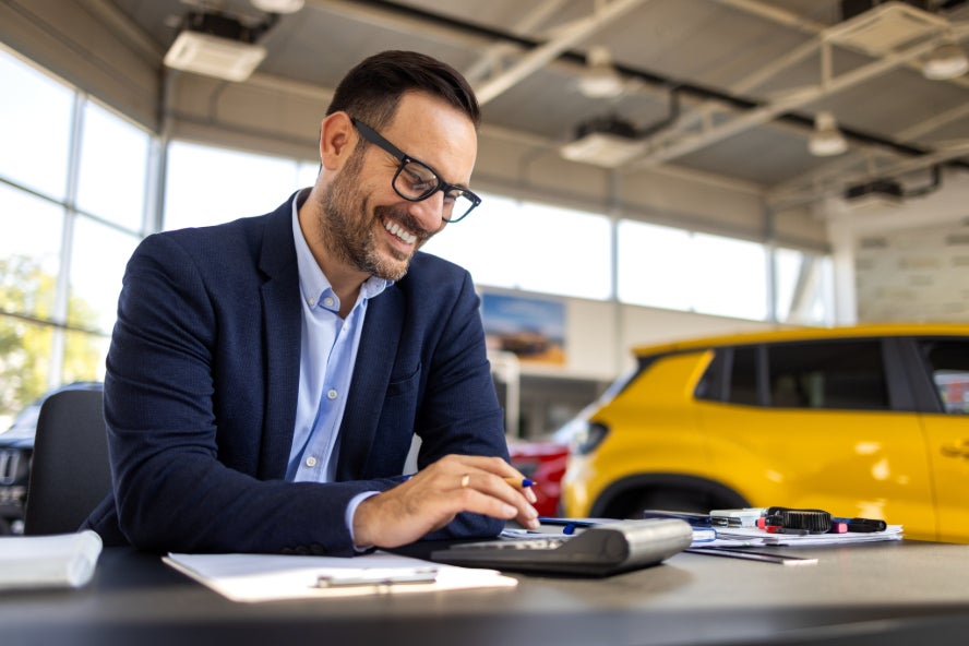 A man working in a car dealership.