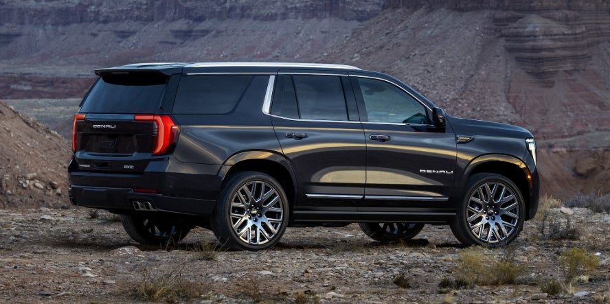 A black GMC Yukon in a desert plateau.